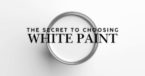 A paint can filled with white paint viewed from above, with the text “The Secret to Choosing White Paint” centered over the image on a white background.