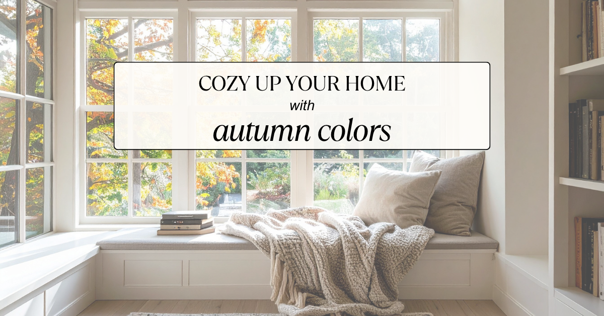 A cozy window seat with cushions and a blanket overlooks trees with autumn foliage. Text overlay reads, "Cozy up your home with autumn colors." Bookshelves frame the bright, inviting space.