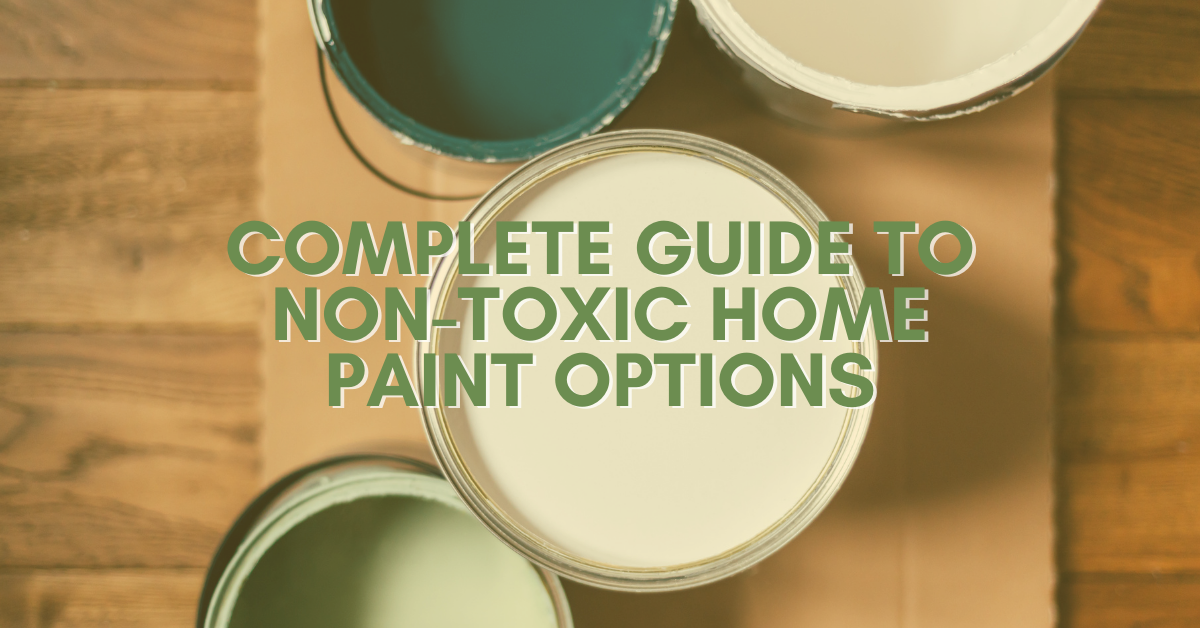 Open cans of paint in various colors are arranged on a wooden surface with text overlay: "Complete Guide to Non-Toxic Home Paint Options.