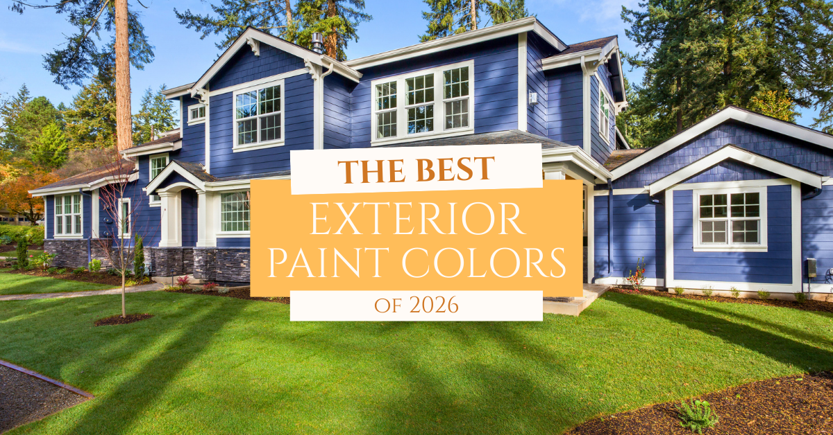 A large two-story house with blue exterior paint and white trim is surrounded by trees and a well-manicured lawn. Text overlay reads: “The Best Exterior Paint Colors of 2026.”.