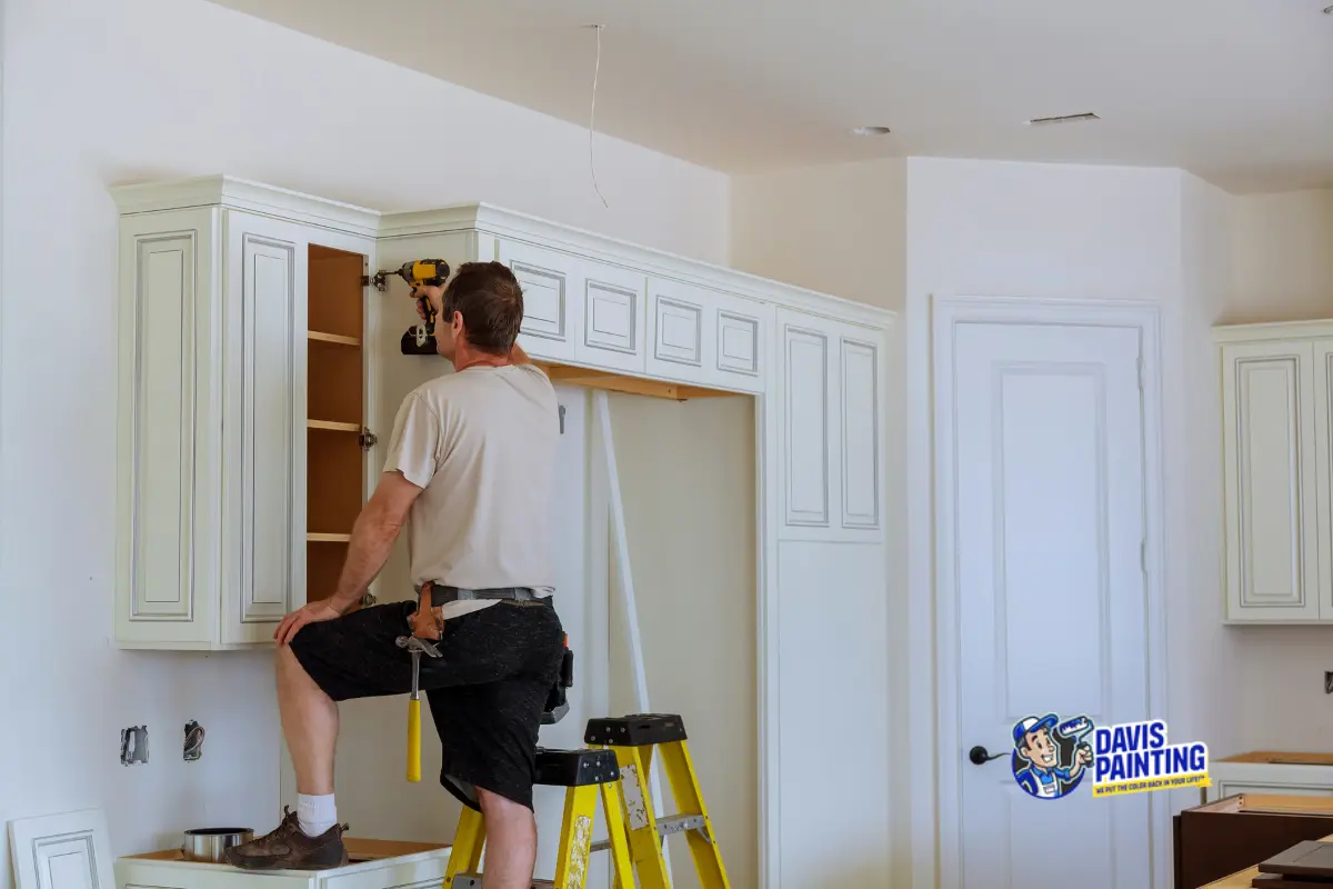 Cabinet painting and replacement — professional installing white kitchen cabinets in a Pennsylvania home renovation
